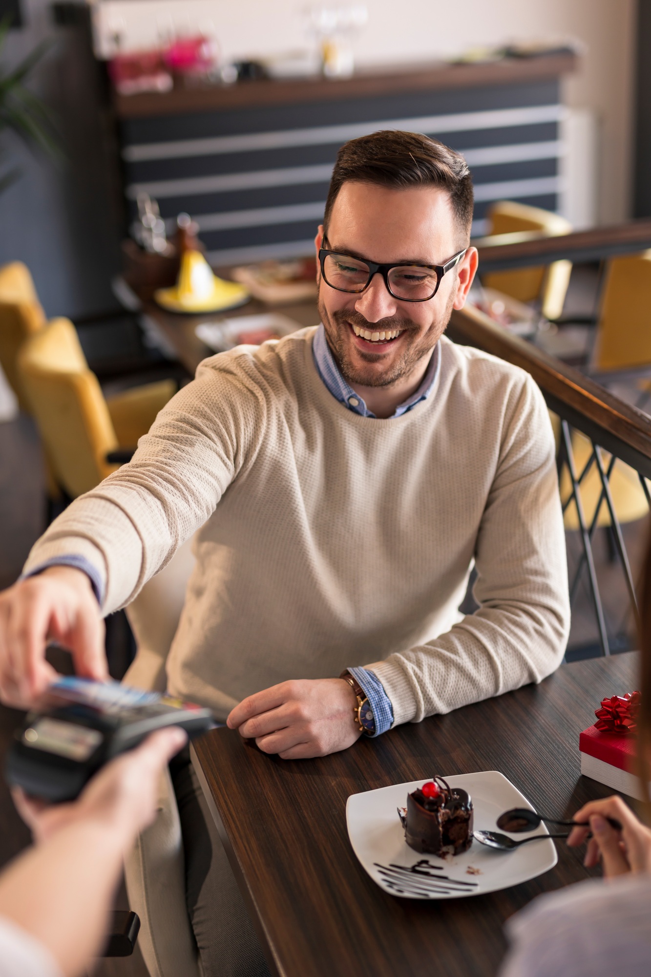 Couple paying check in restaurant via credit card